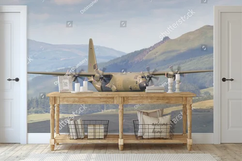 Zielony Lockheed C-130 Hercules nad malowniczym krajobrazem
